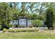 Elegant community entrance sign reading 'Heron Landing' surrounded by manicured landscaping and mature trees at 6800 Dunlin Ct, Sarasota, FL 34241