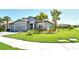 Charming home showcasing a verdant lawn, three-car garage, and swaying palm trees, creating a tranquil setting at 6800 Dunlin Ct, Sarasota, FL 34241