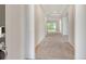 Bright foyer featuring neutral carpeting and high ceilings leading to the open living space at 6800 Dunlin Ct, Sarasota, FL 34241