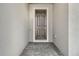 The home's entry featuring a classic black door and a neat paver walkway, blending simplicity with sophistication at 6800 Dunlin Ct, Sarasota, FL 34241
