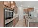 Granite countertops, stainless steel appliances, and rich wood cabinetry in a modern kitchen at 6800 Dunlin Ct, Sarasota, FL 34241