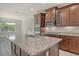 Modern kitchen features granite countertops, stainless steel appliances, and wood cabinetry at 6800 Dunlin Ct, Sarasota, FL 34241