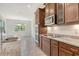 Modern kitchen features granite countertops, stainless steel appliances, and wood cabinetry at 6800 Dunlin Ct, Sarasota, FL 34241