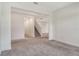 An open living room leads to a staircase with neutral walls and flooring at 6800 Dunlin Ct, Sarasota, FL 34241