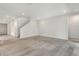 Spacious area featuring plush carpeting, white walls, and a staircase leading to the upper floor at 6800 Dunlin Ct, Sarasota, FL 34241