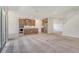 Open floor plan connecting the kitchen, dining, and living areas with neutral carpet at 6800 Dunlin Ct, Sarasota, FL 34241