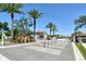 Beautiful street view showcasing well-maintained homes, mature palm trees, and a secure gated entrance at 6800 Dunlin Ct, Sarasota, FL 34241