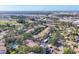 Wide aerial view of the community featuring beautiful landscaping, a pond, and convenient access to amenities at 752 White Pine Tree Rd # 101, Venice, FL 34285