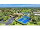 Great aerial view of the tennis courts, community features, and manicured grounds at 752 White Pine Tree Rd # 101, Venice, FL 34285