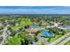 Aerial view of the community featuring tennis courts, pool, and clubhouse at 752 White Pine Tree Rd # 101, Venice, FL 34285