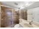 Bathroom with a large frosted glass shower and a white sink and vanity combo at 752 White Pine Tree Rd # 101, Venice, FL 34285