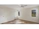 Neutral bedroom featuring wood-look flooring, a ceiling fan, and natural light from windows at 752 White Pine Tree Rd # 101, Venice, FL 34285