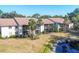 Inviting condo exterior featuring a beautiful lakeside view and well-maintained landscaping at 752 White Pine Tree Rd # 101, Venice, FL 34285