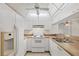 Bright kitchen features white appliances, cabinets and neutral countertops at 752 White Pine Tree Rd # 101, Venice, FL 34285