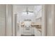 Clean kitchen showcasing white cabinetry, appliances, ceiling fan and neutral countertops at 752 White Pine Tree Rd # 101, Venice, FL 34285