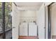 Laundry room with side-by-side washer and dryer and wire shelving at 752 White Pine Tree Rd # 101, Venice, FL 34285