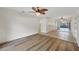 Open living area featuring hard surface floors, ceiling fan, and access to the kitchen at 752 White Pine Tree Rd # 101, Venice, FL 34285
