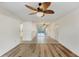 Open living area with hardwood floors and a ceiling fan at 752 White Pine Tree Rd # 101, Venice, FL 34285