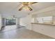 Open living area featuring tile flooring, ceiling fan, and access to the kitchen at 752 White Pine Tree Rd # 101, Venice, FL 34285