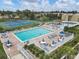 Inviting swimming pool and tennis courts, surrounded by lounge chairs, umbrellas, and manicured landscaping at 752 White Pine Tree Rd # 101, Venice, FL 34285