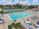 Refreshing pool and tennis courts surrounded by lounge chairs and a well-maintained patio area at 752 White Pine Tree Rd # 101, Venice, FL 34285