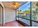 Screened patio with a ceiling fan and view of tropical landscaping at 752 White Pine Tree Rd # 101, Venice, FL 34285