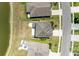 An aerial view of a neatly kept home with a white fence, adjacent to a tranquil pond, showcasing the property's serene setting at 7822 110Th E Ave, Parrish, FL 34219