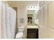 Well-lit bathroom featuring a granite vanity, framed mirror, modern fixtures, and decorative shower curtain at 7822 110Th E Ave, Parrish, FL 34219