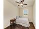 Cozy bedroom with a ceiling fan, wood floors, a large window, and a charming vintage nightstand at 7822 110Th E Ave, Parrish, FL 34219