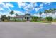 Exterior shot of the community clubhouse featuring a manicured landscape, palm trees and a welcoming entrance at 7822 110Th E Ave, Parrish, FL 34219