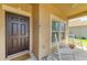 Close up on the front porch with white rocking chairs on the porch at 7822 110Th E Ave, Parrish, FL 34219
