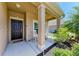 The front porch features comfortable seating and decorative plants, perfect for relaxing outdoors at 7822 110Th E Ave, Parrish, FL 34219