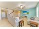 Comfortable living room featuring tile floors, light blue accent wall, ceiling fan, and large windows at 7822 110Th E Ave, Parrish, FL 34219