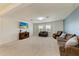 Spacious living room with large windows, a TV, and comfortable furniture at 7822 110Th E Ave, Parrish, FL 34219
