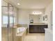 Elegant main bathroom with a glass-enclosed shower, large tub, dual sinks, and ample natural light at 7822 110Th E Ave, Parrish, FL 34219