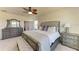 Spacious main bedroom features a bench, ceiling fan, and view of the en suite bathroom at 7822 110Th E Ave, Parrish, FL 34219