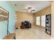 Office space with light-colored walls, tile flooring, a ceiling fan, and large windows at 7822 110Th E Ave, Parrish, FL 34219