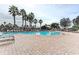 Beautiful community pool surrounded by palm trees and plenty of lounge seating at 7822 110Th E Ave, Parrish, FL 34219