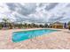 Community pool with tables, umbrellas, and comfortable lounge chairs at 7822 110Th E Ave, Parrish, FL 34219