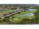 Panoramic aerial view of community surrounded by lush greenery and picturesque lakes at 8205 Grand Estuary Trl # 101, Bradenton, FL 34212