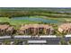 Beautiful aerial view of the condo building overlooking a scenic lake and golf course at 8205 Grand Estuary Trl # 101, Bradenton, FL 34212