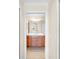 Bathroom featuring a wood vanity, white countertop, and a large mirror with decorative lighting at 8205 Grand Estuary Trl # 101, Bradenton, FL 34212