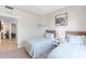 A bedroom has two twin beds with wicker headboards and matching side tables at 8205 Grand Estuary Trl # 101, Bradenton, FL 34212