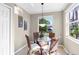 A dining area features a glass-topped table and wicker chairs at 8205 Grand Estuary Trl # 101, Bradenton, FL 34212