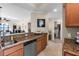 A kitchen with granite countertops looks out over the living area at 8205 Grand Estuary Trl # 101, Bradenton, FL 34212