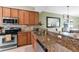 A kitchen features granite countertops and stainless steel appliances at 8205 Grand Estuary Trl # 101, Bradenton, FL 34212