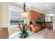 A kitchen with granite countertops and wood cabinets sits adjacent to a dining area at 8205 Grand Estuary Trl # 101, Bradenton, FL 34212