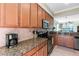 A kitchen features granite countertops and stainless steel appliances at 8205 Grand Estuary Trl # 101, Bradenton, FL 34212