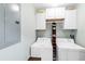 Bright laundry room features white appliances and ample storage cabinets above the washer and dryer at 8205 Grand Estuary Trl # 101, Bradenton, FL 34212