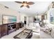 Bright, airy living room with a large TV, comfortable seating, and an open view to the dining area at 8205 Grand Estuary Trl # 101, Bradenton, FL 34212